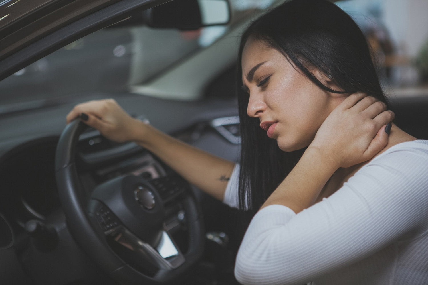 Woman holding her neck after a car accident